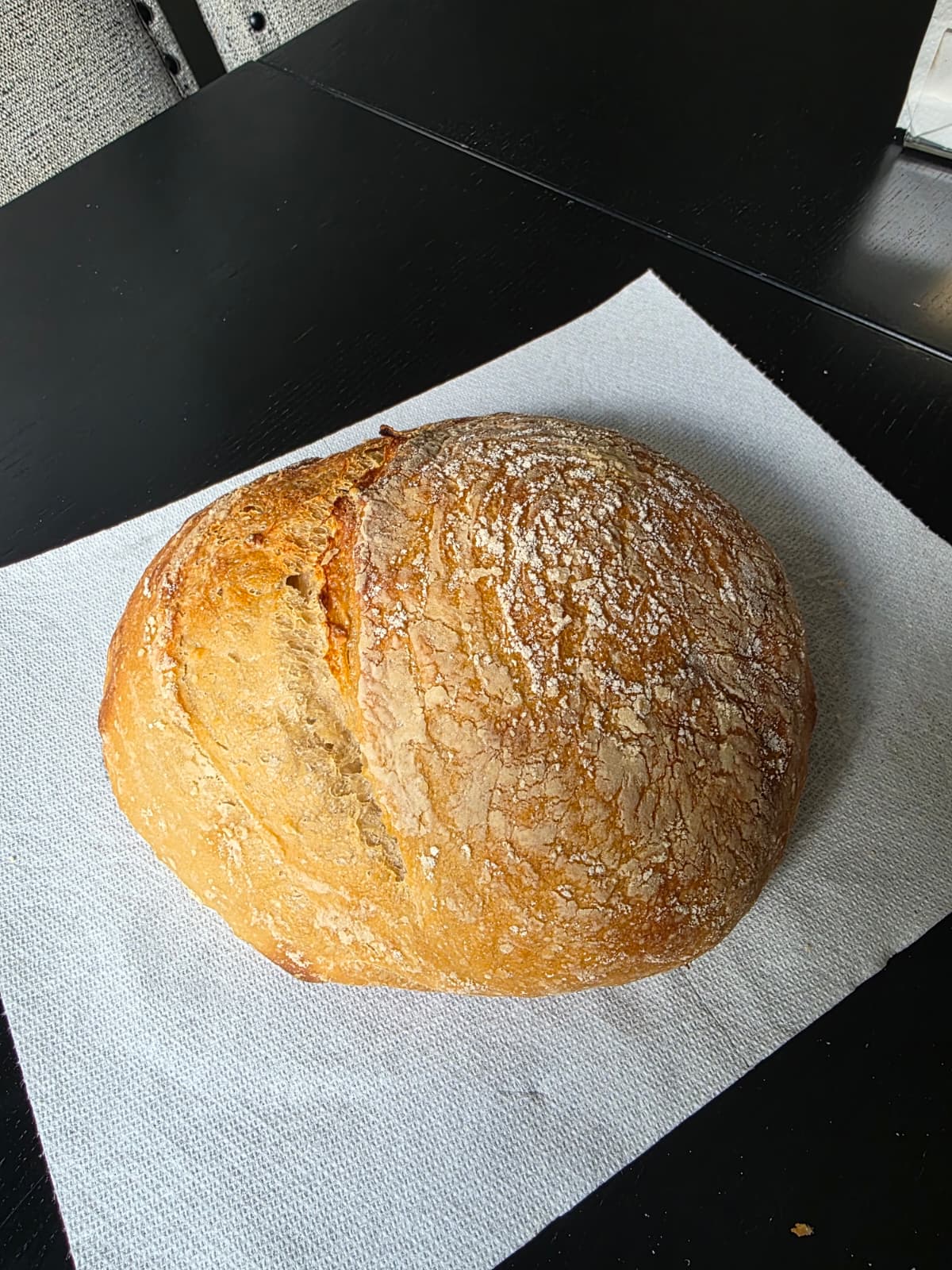 A freshly baked, flour-dusted sourdough loaf